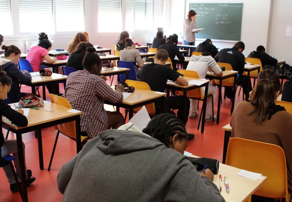 Teenagers in a classroom revising for an exam