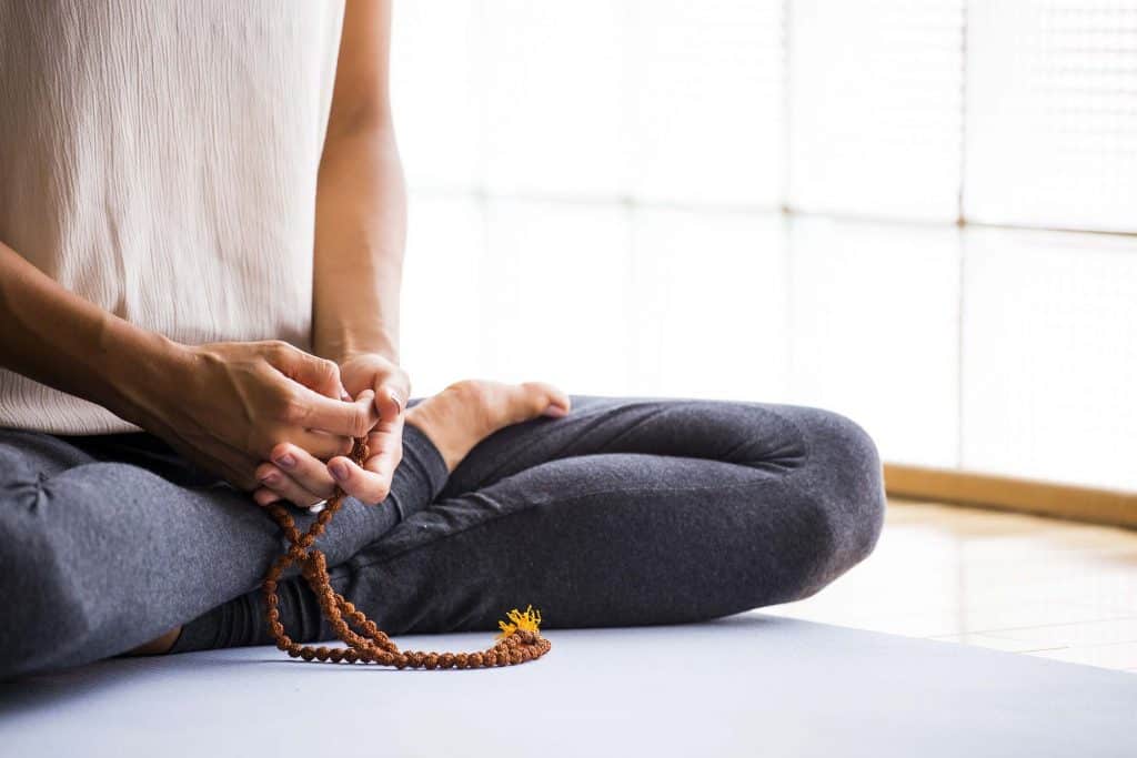Woman sitting cross-legged in meditation